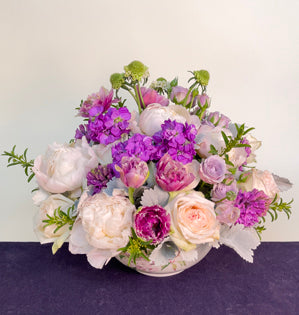A luxurious arrangement filled with fragrant blooms such as, eriostemon, peonies, White O'Hara roses, stock, and hyacinth paired with, spray roses, fringed tulips, scabiosa, and dusty miller.