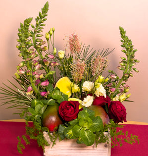 Cute wooden box with a whimsical arrangement of disflexus, foxglove, grevillea, Garden Romance garden roses, Lisianthus, kale and mangoes as the star.