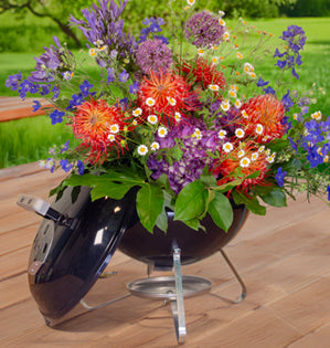 A grill filled with beautiful summer flowers.