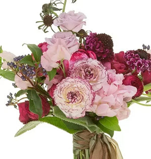 Bouquet of pink and purple flowers with green leaves on a white background